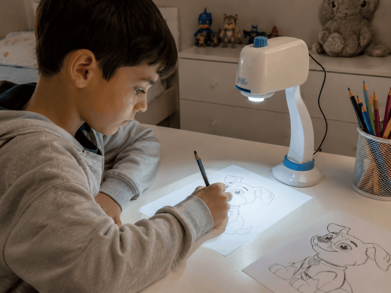 Child using a Smart Sketcher projector to trace a drawing